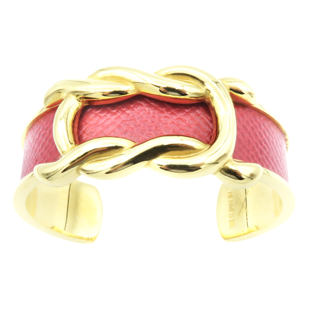 Bracelet Hermes Métal Doré Rigide ouvert avec cuir rouge . Bracelet Hermes Métal Doré Rigide ouvert avec cuir rouge .