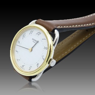 Montre Hermes  dame "Arceau" Or et Acier . Quartz. 25 mm.