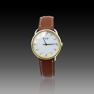 Montre Hermes  Dame "Arceau" Or et Acier . Quartz. 30 mm.