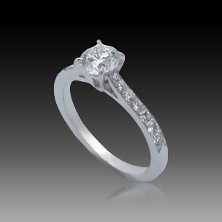 Solitaire en Or gris 18 Cts avec Diamant brillant 0.76 Cts K-VS1 + 0.10 Cts.